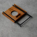 picture of the Flat Green foldable dripper stand folded and lying on the floor