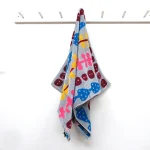 My Cat's Diary bath Towel - grey, hanging on the wall