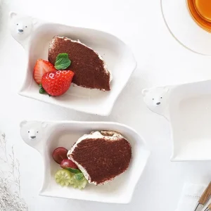 三個Yoshizawa 益子燒北極熊造型小碗放在桌上，左邊和中間的碗裡有甜點，右邊的碗是空的 - Three Yoshizawa Mashiko-style polar bear-shaped small bowls on a table, with the left and middle bowls containing dessert, and the right bowl empty.