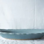 藍灰色Yoshizawa 益子燒盤子放在枱上的側面圖片