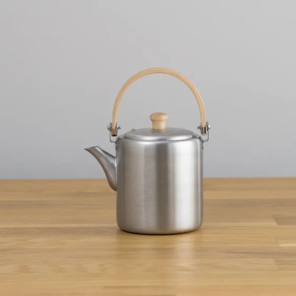 相澤工房 BP直筒茶壺 - 弦手柄款式，茶壺嘴向左邊放在木枱上的展示筒