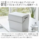 TOWER 熨斗收納箱放在房間的白色枱面上，背景可見窗外景色