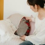 一位女士坐在梳化上,雙手輕扶放在旁邊的松尾美由紀 貓咪造型抱枕 - Leo