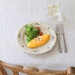 Studio M’ 2025 秋冬新系列 Rosier 圓餐盤裝着食物放在枱面,旁邊有刀叉及飲品。